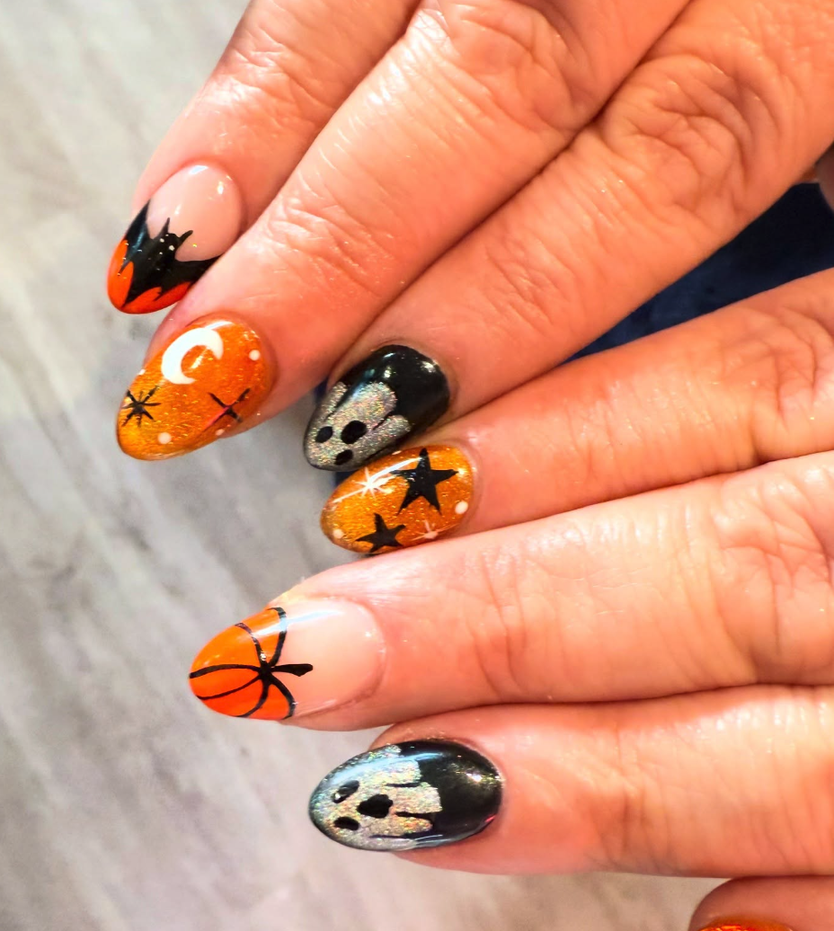 Glitter & Ghouls – Sparkly orange nails with silver ghosts, pumpkins, bats, and stars that shine under any light.