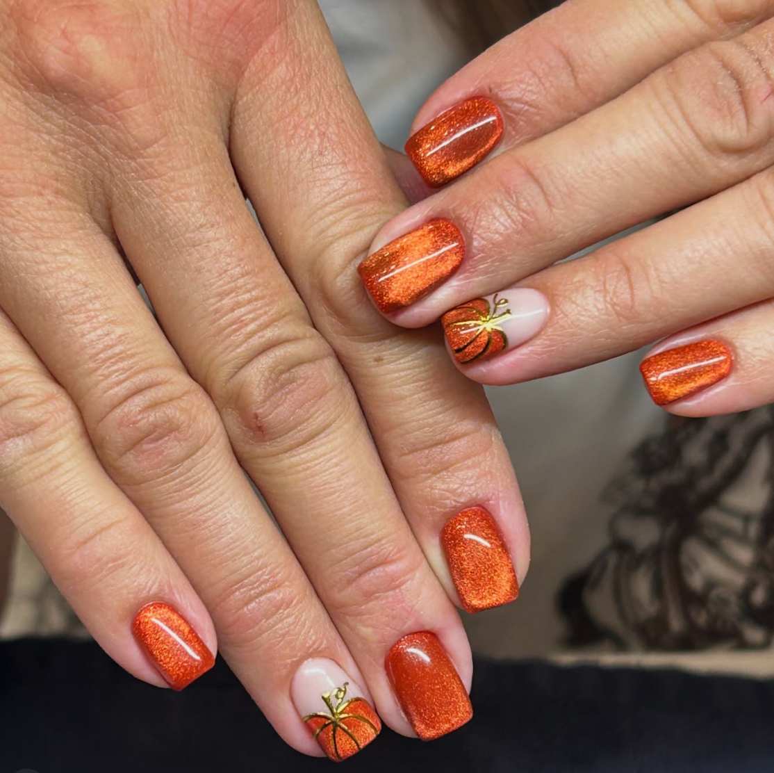 Pumpkin Sparkle – Shimmery orange polish with accent pumpkins that scream cozy Halloween nights.