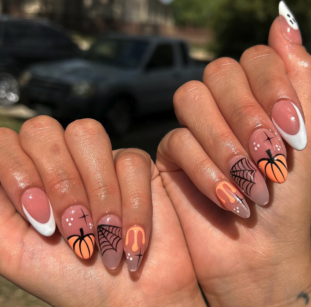 Pumpkin & Webs – Almond-shaped nails with glowing pumpkins, webs, and dripping details for a glam-spooky style.
