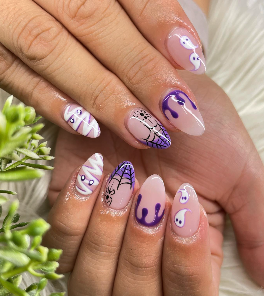Purple Potion Nails – Mummies, webs, ghosts, and drips all in purple for a fun and witchy Halloween manicure.