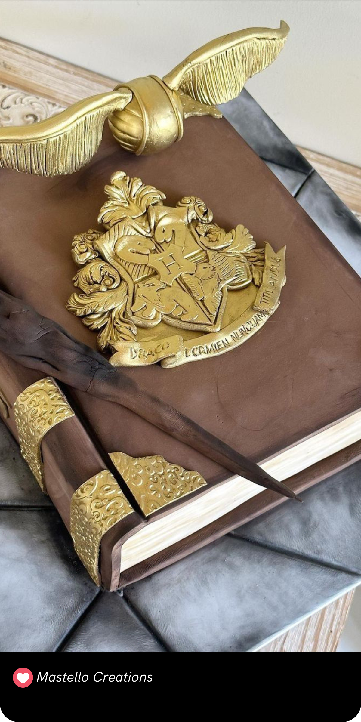 This magical cake is a beautifully detailed tribute to the wizarding world! With a golden snitch perched on top, the design resembles an ornate book, complete with the Hogwarts crest embossed in gold. The cake’s fine detailing, from the quill to the decorative edges, makes it a perfect celebration piece for any Harry Potter fan.