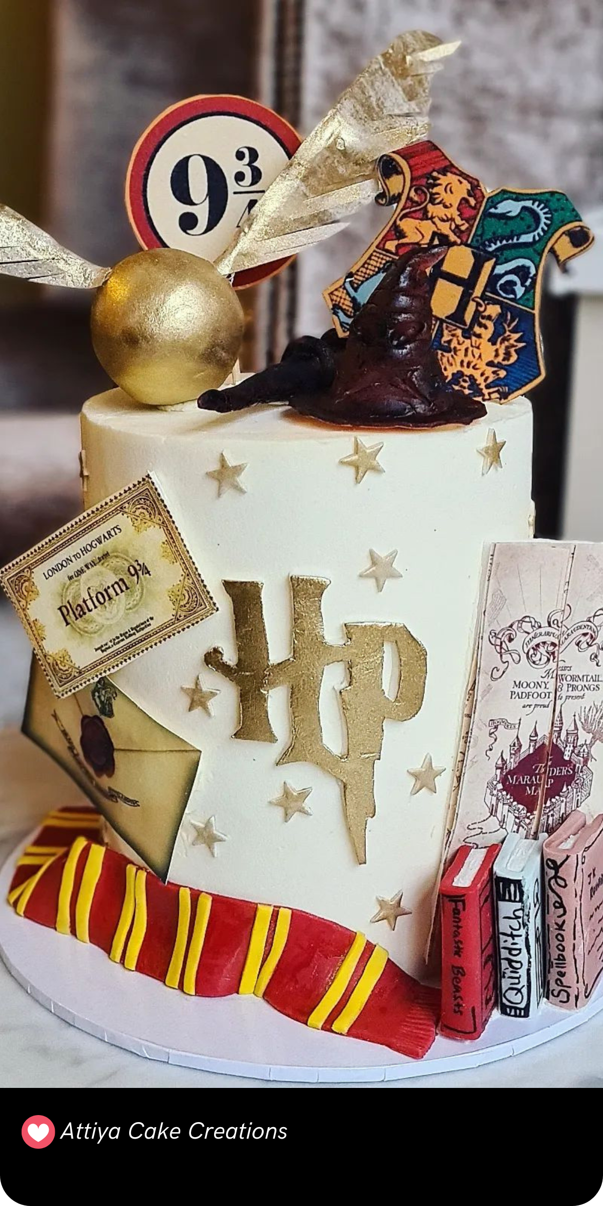 This delightful Harry Potter cake is filled with iconic elements from the wizarding world! The design showcases a golden snitch, a Platform 9¾ sign, the Sorting Hat, and the Hogwarts crest, all beautifully crafted on a white fondant base. The Gryffindor scarf wraps around the bottom, adding a pop of color, while spellbooks and a Marauder's Map complete the magical details. It’s a charming tribute to the series, perfect for any fan's celebration!