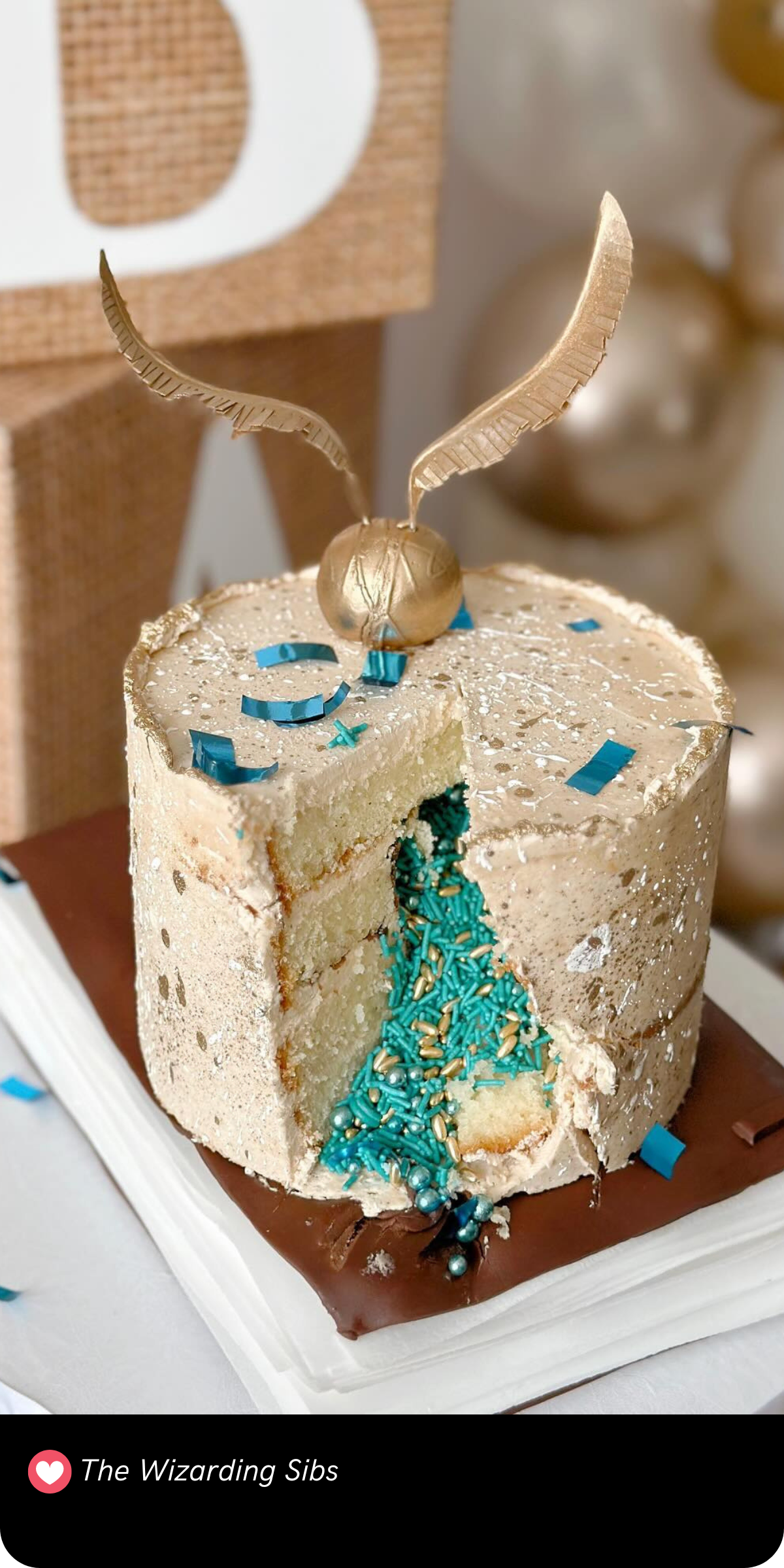 This surprise-inside cake is pure wizardry! Topped with a delicate golden snitch, the cake features a hidden cascade of blue and gold sprinkles revealed upon cutting. The simple, speckled buttercream exterior beautifully contrasts with the magical sprinkle explosion inside, making it a delightful centerpiece for any Harry Potter-themed celebration!