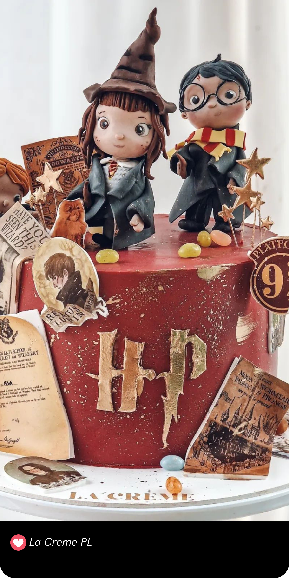 This delightful Harry Potter cake captures the charm of the wizarding world with adorable handcrafted figures of Harry, Ron and Hermione. Set against a deep red base with golden splatters, the cake is packed with details like the Sorting Hat, Hogwarts letters, and famous wizarding paraphernalia such as the Marauder’s Map and Platform 9¾ sign. The playful and cute character designs make this cake a fun and whimsical tribute to the magic of Hogwarts!