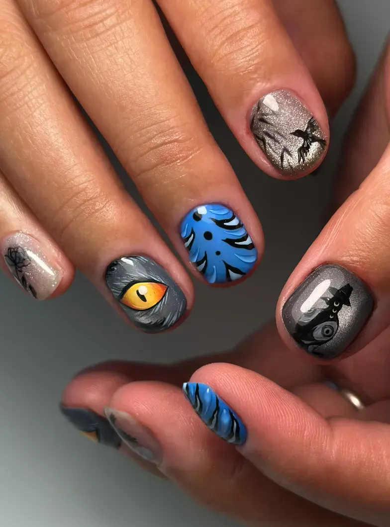 Sharp detail and glowing yellow eyes take this mani to the next level. Add in shadowy blue tones, and you’ve got a perfectly spooky statement set.