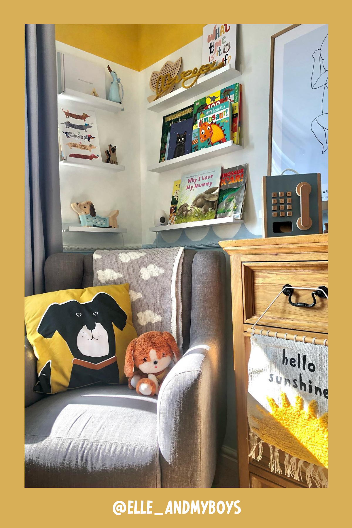 This corner nook is pure sunshine! With a cozy gray armchair adorned with a dog-themed pillow and a fluffy stuffed animal, it's the perfect spot to snuggle up with a good book. The floating shelves above are filled with colorful children’s books, while playful decor elements like a 'hello sunshine' wall hanging add a cheerful vibe to the space. It's bright, welcoming, and filled with personality!