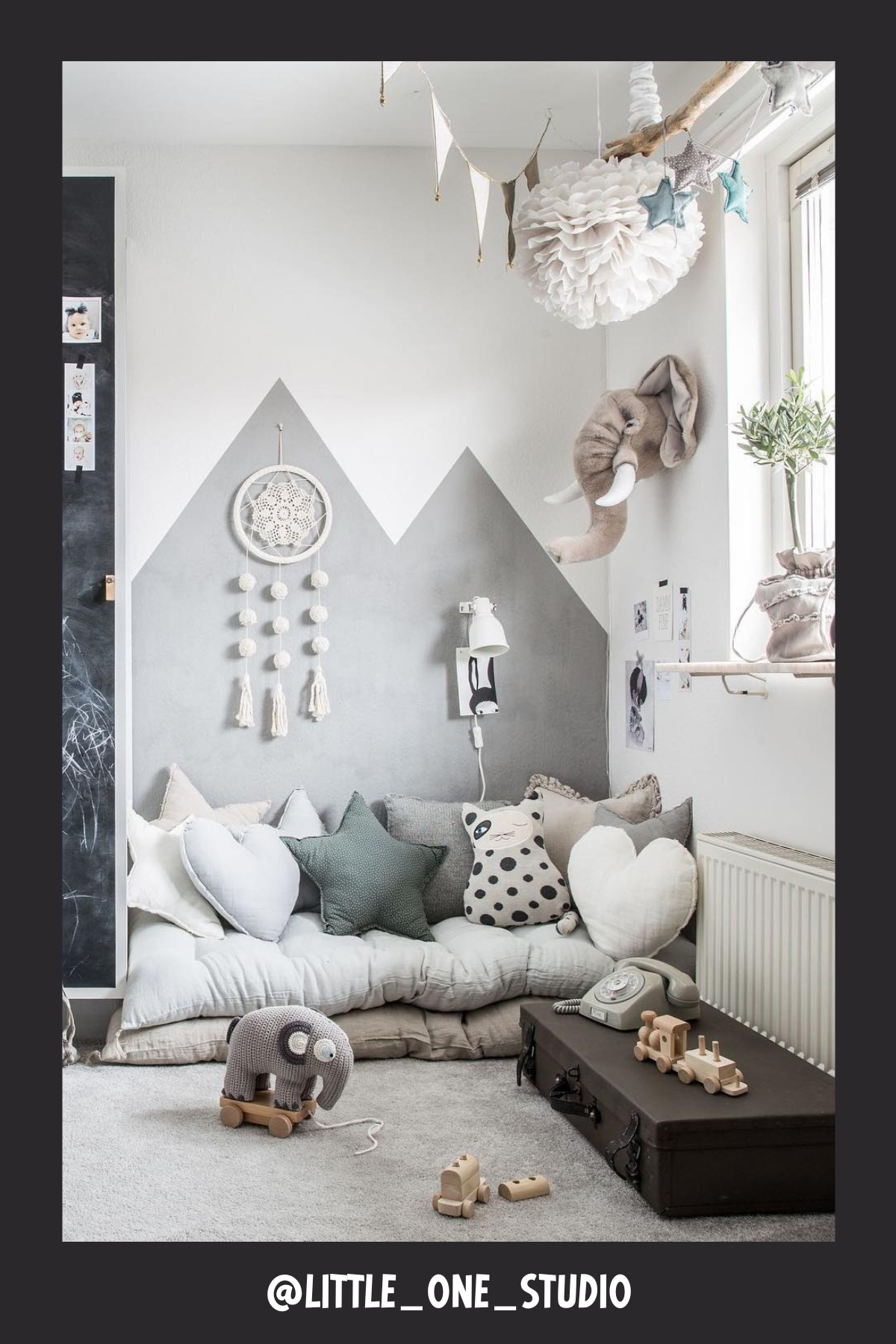 Neutral tones and subtle mountain wall art make this nook feel like a peaceful retreat. The chalkboard wall adds a fun, interactive element, while the plush floor pillows and heart-shaped cushions create a cozy, calming environment. With soft lighting, dreamy decor, and an adorable elephant theme, it's the perfect spot for kids to unwind and enjoy a good book.