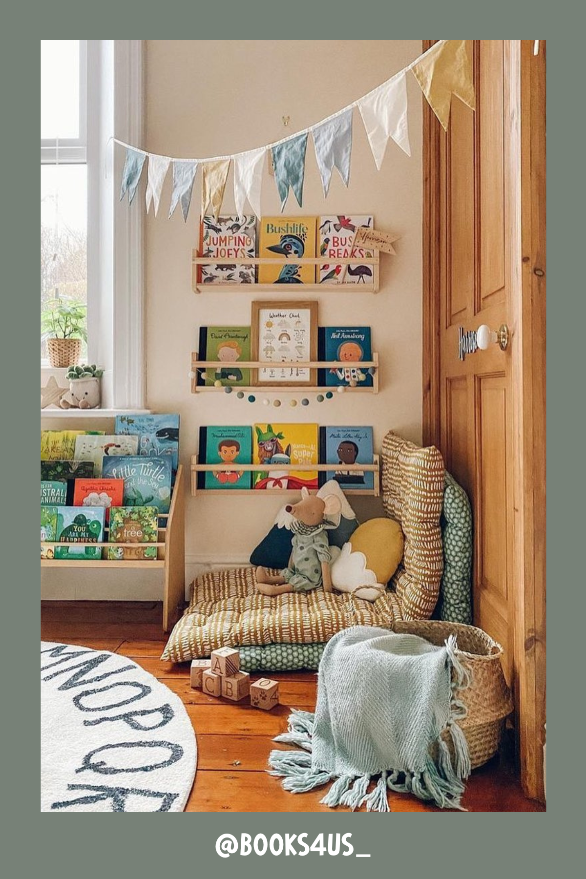 The coziest of corners, this nook is a small book lover's dream! A stack of plush cushions and a quilted mat make it super inviting. The wall-mounted bookshelves offer a range of story options, and a few scattered toys and a garland banner give it that sweet, lived-in charm.