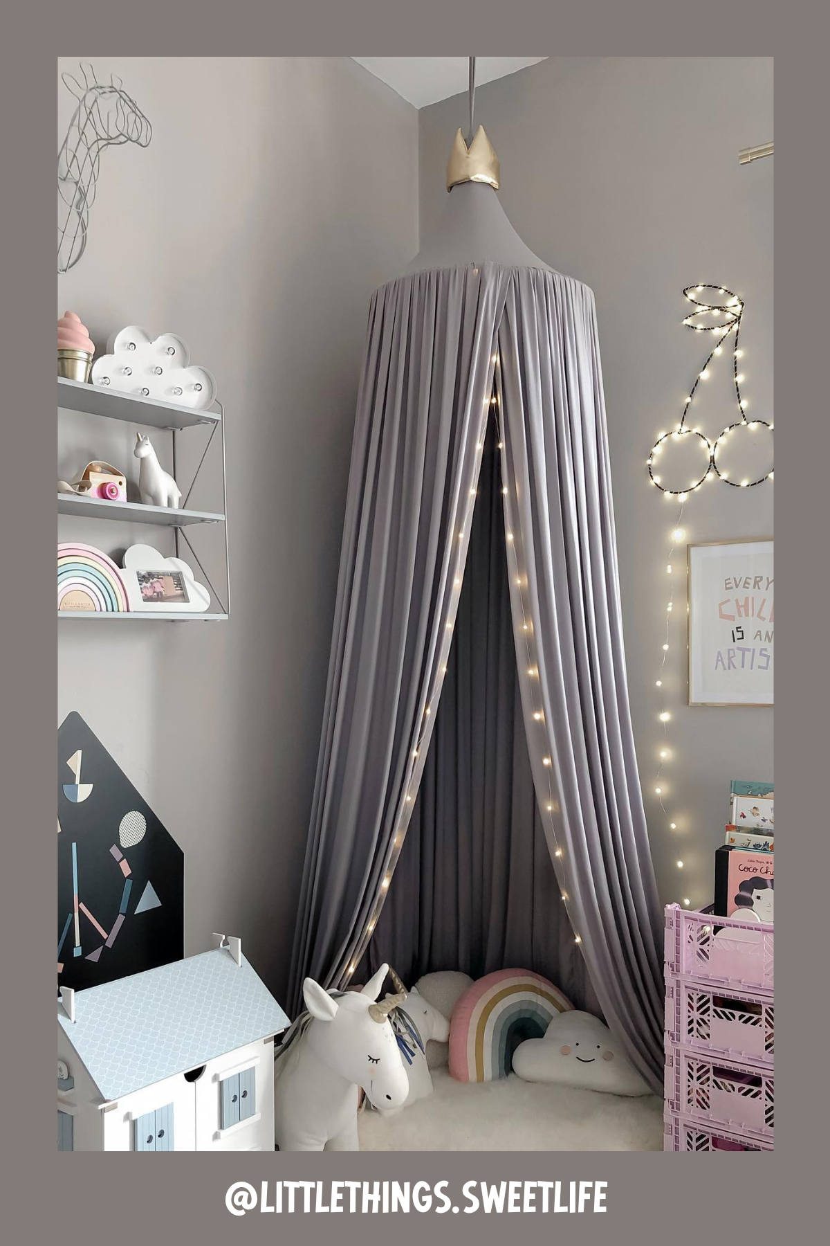 A magical castle-like canopy, fairy lights, and a soft cushioned base make this nook a storytime paradise. The soft gray color scheme paired with rainbow accents gives it a modern yet whimsical feel. Shelves filled with books and unicorn friends complete the space, turning it into a little one's dream reading corner.