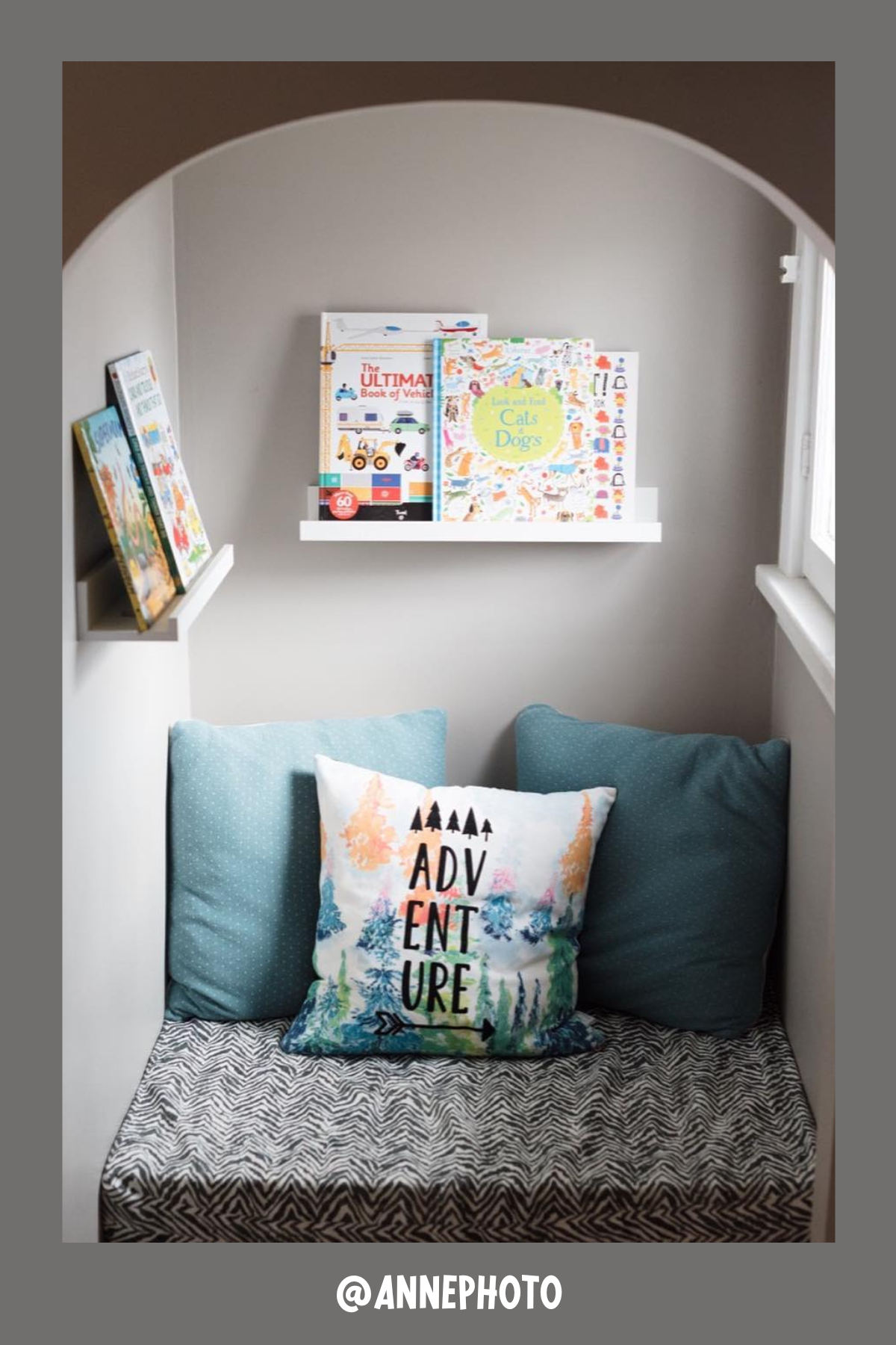 This small but mighty nook is tucked into a cozy corner, complete with an arched opening. The plush seat is piled with teal and patterned pillows, inviting kids to curl up with their favorite tales. Two simple wall shelves hold a delightful array of books, turning this tiny space into an imaginative escape.