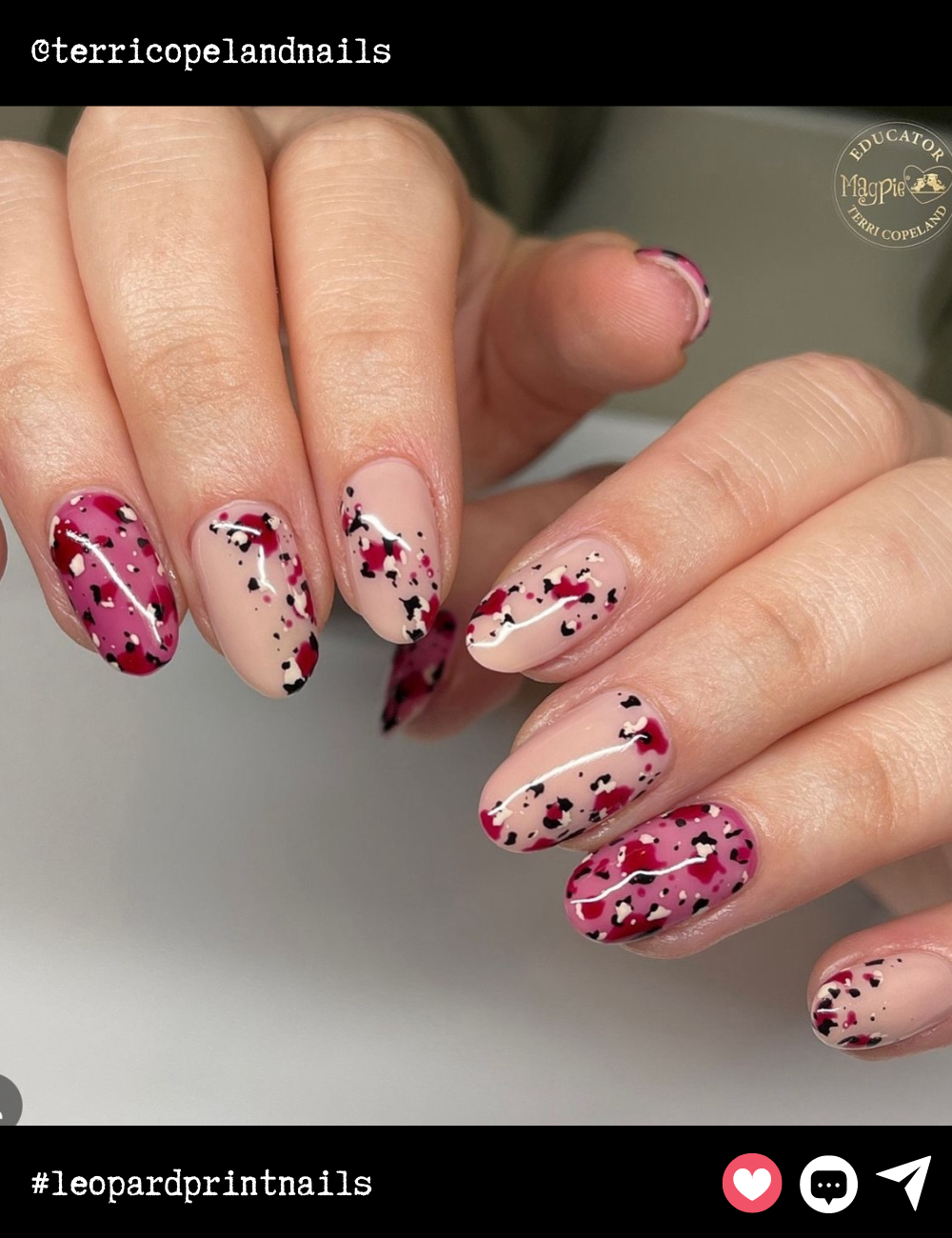 Round almond nails embrace a splash of color with a paint-splatter effect in red, black, and white. These nails are an artsy, abstract take on leopard print—perfect for someone who loves a bit of edge with a pop of color.