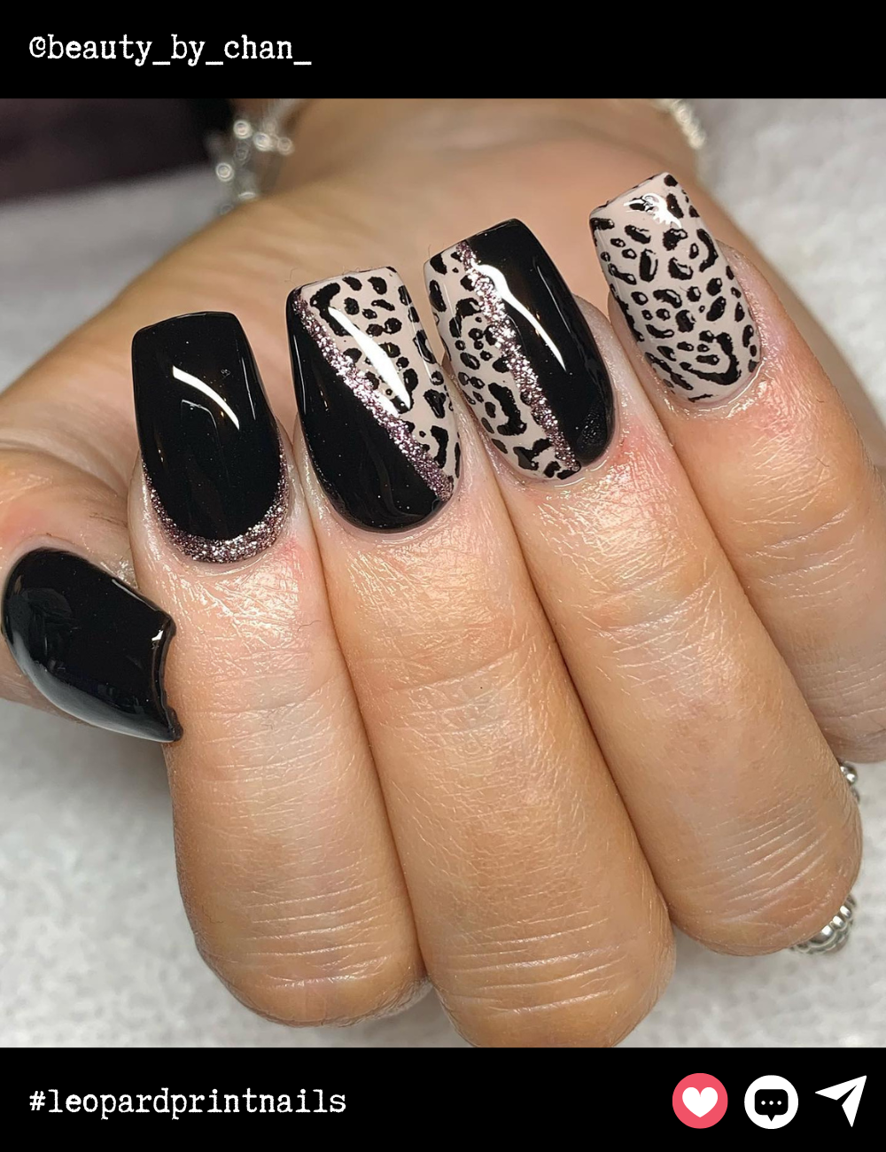 Square-shaped nails with a fierce contrast of sleek black polish and intricate leopard print. The glittery accent line adds a dash of glam while maintaining an edgy vibe. Perfect for making a bold statement!