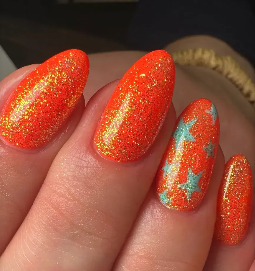 Full glitter orange with teal stars popping through? These nails look like stage lights catching sequins mid-performance. Sparkly, loud, and perfect for singing at the top of your lungs. 🩵🧡 Nail art design inspired by Life of a Showgirl Taylor Swift 🩵🧡