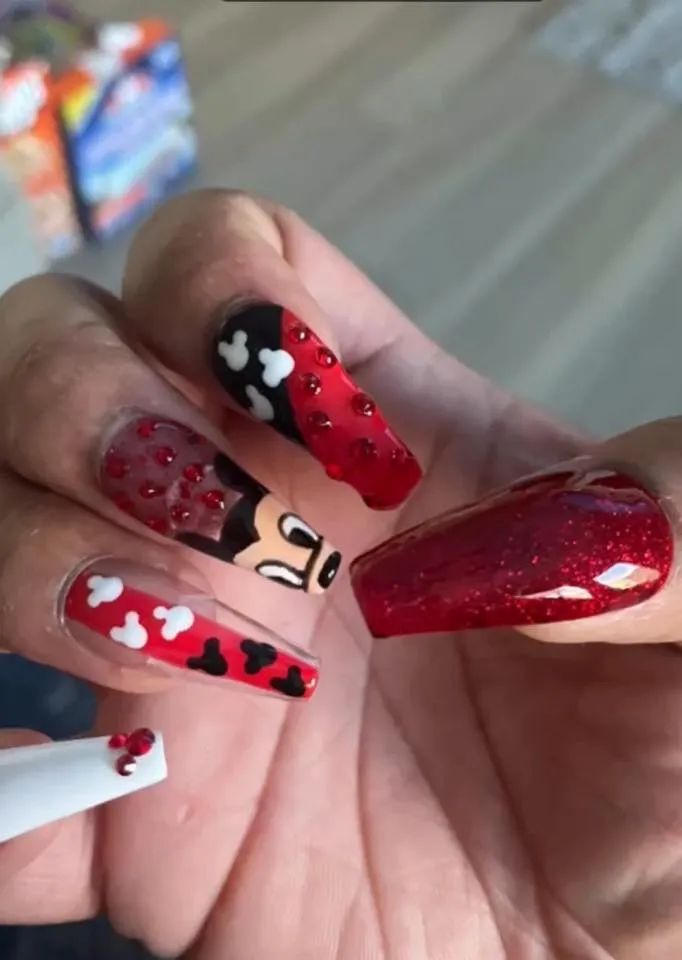 These bold Mickey-inspired coffin nails blend red glitter, black polish, and cute white silhouettes for a fun yet polished look. Perfect for anyone who wants Disney magic with a bit of attitude.