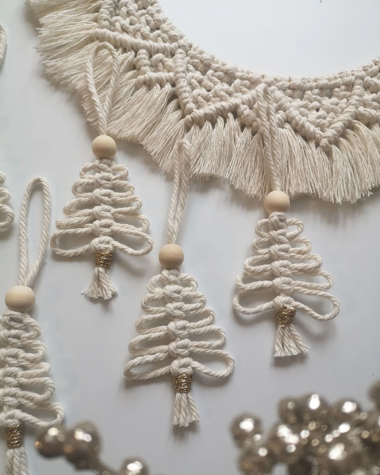 These sweet macrame Christmas tree ornaments bring a perfectly cozy, handmade feel to your decor. The soft cotton cord, wooden bead detail, and touch of shimmer at the base make them beautifully simple yet full of texture. Hang them on your tree, tie them onto gift wrap, or use them as little accents in your garlands — they’re the kind of small detail that makes your whole holiday setup feel warm, natural, and thoughtfully styled.