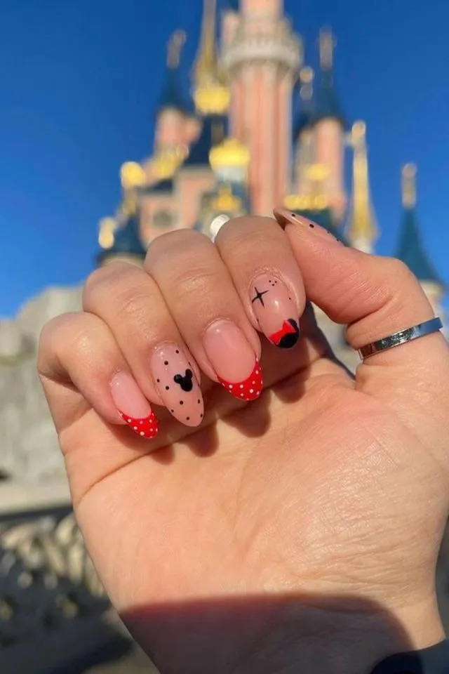 These French tips bring Minnie to the parks! The nude base paired with red polka-dot tips and subtle ear accents is a classy yet playful way to show your Disney side.