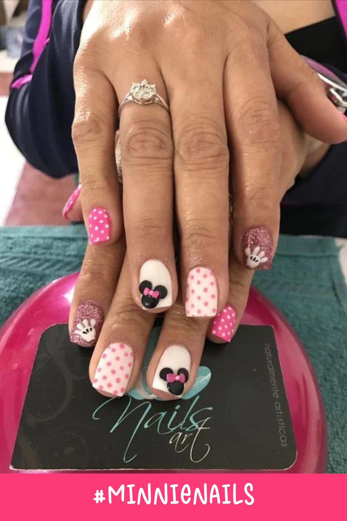 These Disney Minnie nails combine shades of pink with polka-dot accents and glittery tips. The design is completed with a cute Minnie silhouette and a Mickey hand detail, adding a playful twist to this easy Minnie Mouse nail set.