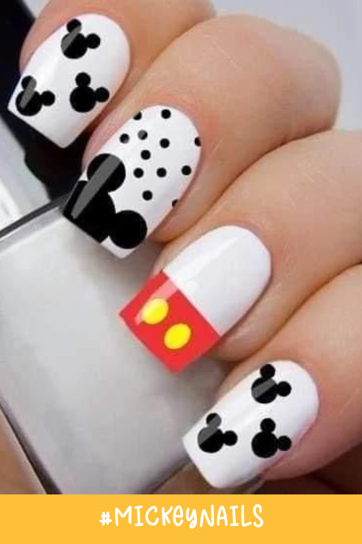 A monochrome palette with bold Mickey silhouettes defines this design. The mix of black polka dots on a white base and a pop of Mickey's iconic red shorts make this set a stylish take on Disney design nails.