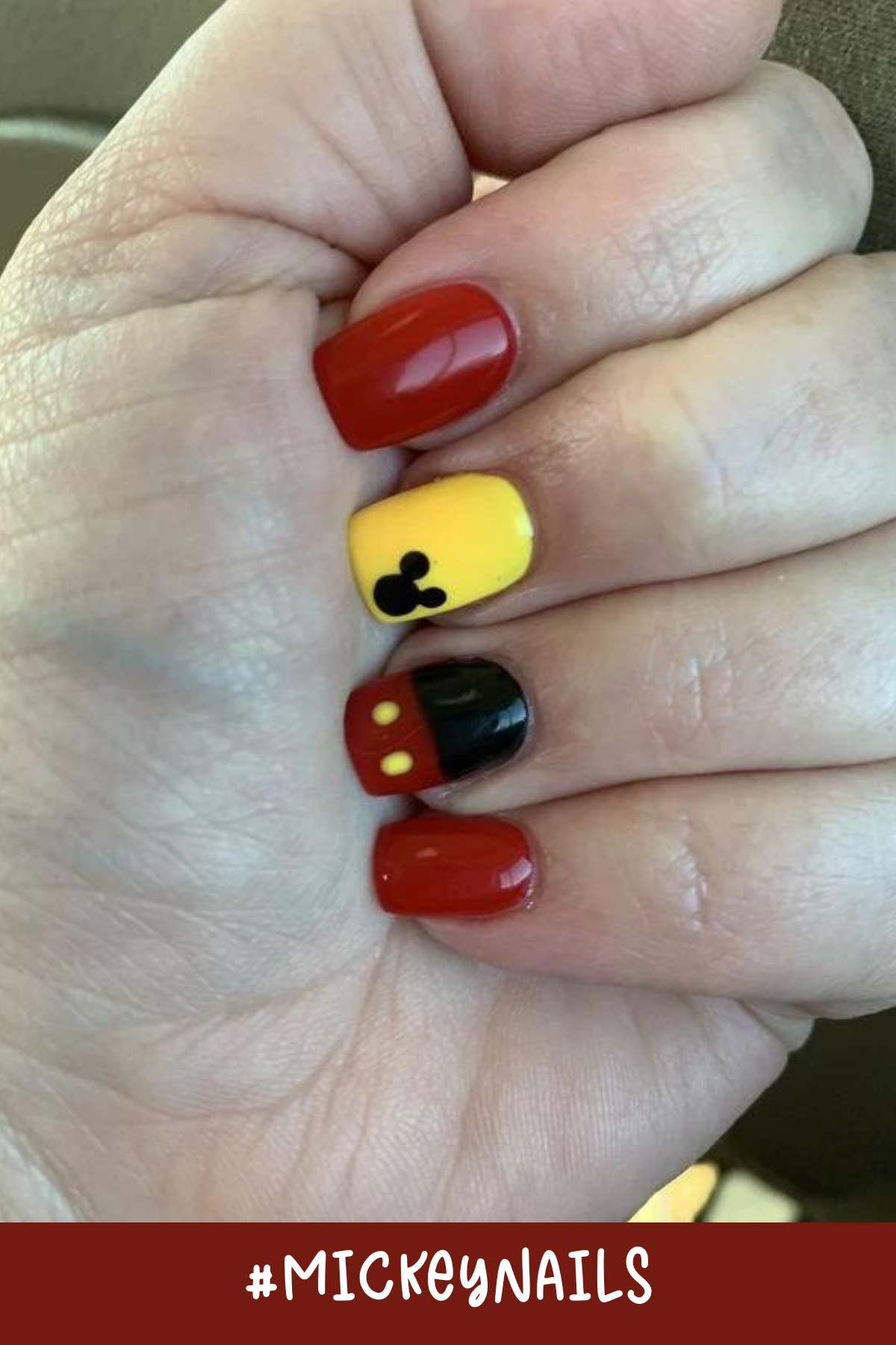 These Mickey Mouse short nails highlight a bright yellow accent nail paired with classic red and black designs. The minimalist Mickey silhouette adds a cute touch, perfect for Disney vacations.