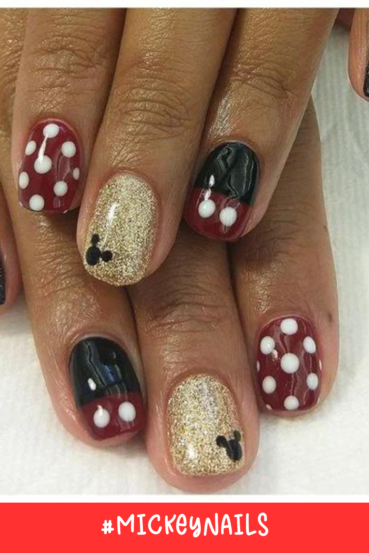 A mix of red, black, and gold with polka dots creates these simple Mickey-inspired nails. The gold accent nails with tiny Mickey silhouettes add a touch of sparkle, while the red and black nails represent Mickey's iconic outfit.