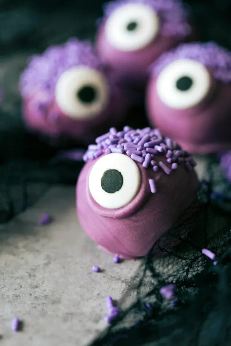 Purple Monster Cake Pops – Covered in purple candy melts and topped with a single giant eye, these one-eyed monster pops are equal parts silly and spooky.