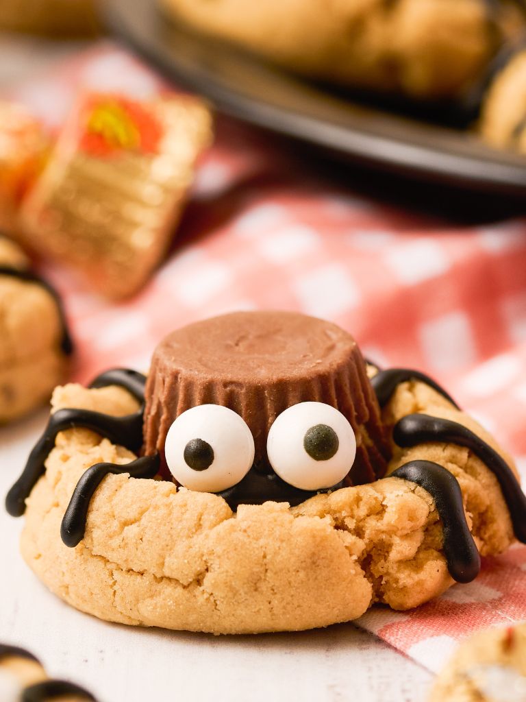Soft peanut butter cookies topped with mini peanut butter cups and candy eyes transform into the cutest creepy crawlies. The chocolate legs give just the right amount of âickâ without being too scary for little ones!