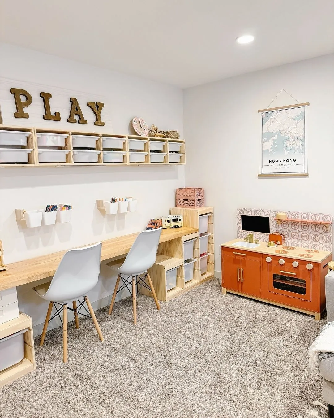 Creative & Organized Playroom – A sleek and modern play space featuring a long workbench, labeled storage, and a mix of play and learning areas for endless creativity.