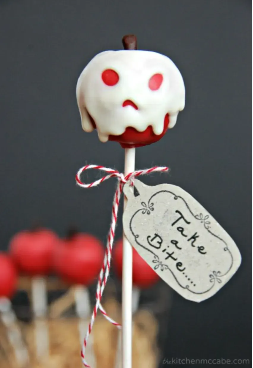 Poison Apple Cake Pop – Inspired by Snow White’s iconic apple, this spooky treat features a red cake pop draped in white chocolate “poison” with a chilling stare and a tag that dares you to "Take a Bite."