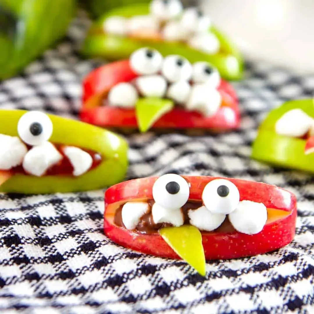A healthier Halloween treat! Apple slices turn into goofy monsters with mini marshmallow teeth, candy eyeballs, and tongues made from sliced fruit or veggies.