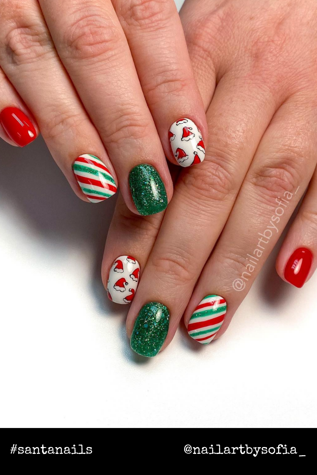 Green and Candy Cane Delight: A vibrant mix of red, green, and candy cane stripes! The Santa hat accents add the perfect touch for anyone seeking cool Christmas nails with a pop of color.