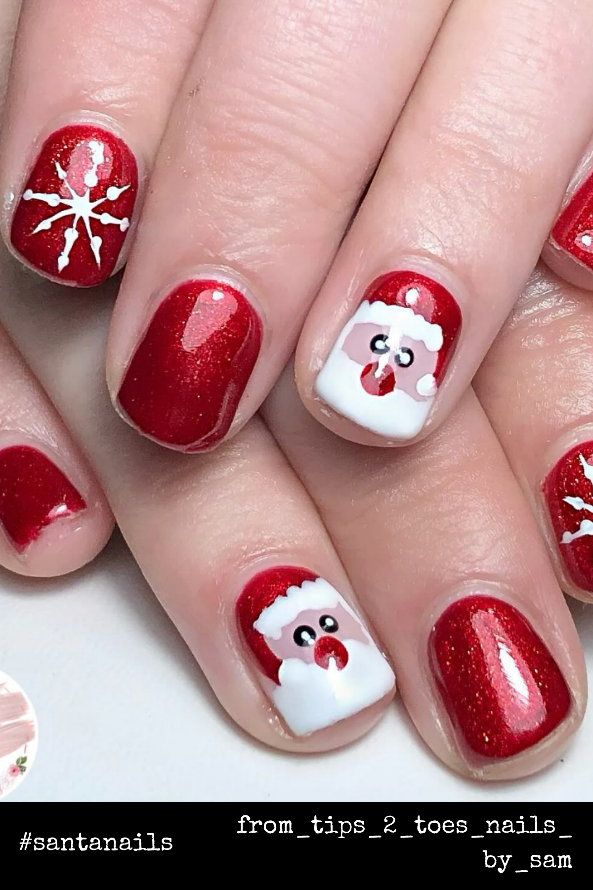 Glittering Santa Accents: A red glitter base and adorable Santa faces make this nail design pure holiday perfection. Add some snowflakes for the ultimate Christmas nail inspo!