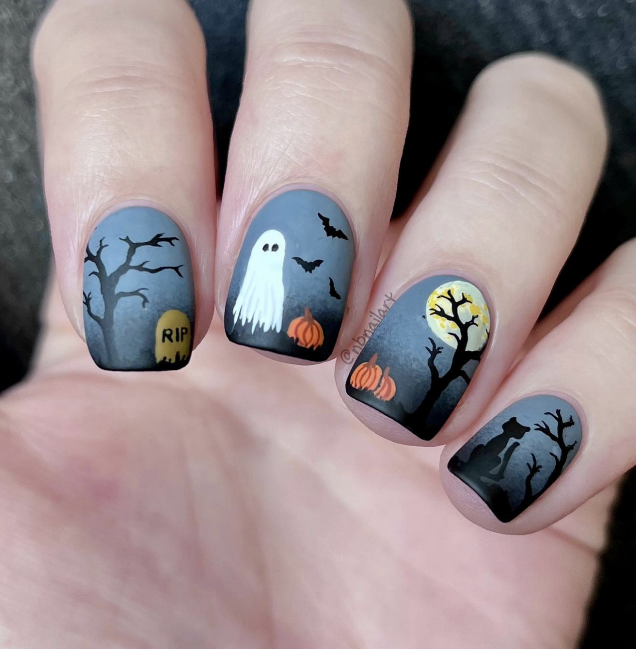 These Halloween nails are like a mini spooky scene on each fingertip—absolutely perfect for those who love a detailed, eerie vibe! The whole design has a moody, misty gray background that sets the tone for the haunting elements while letting the darker details stand out.