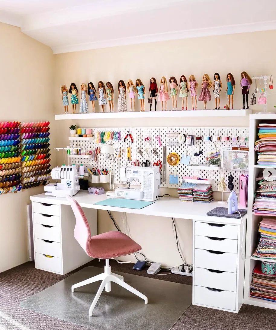 A dual pegboard setup works wonders for sewing supplies, while the nearby shelf for fabric keeps everything neatly organized and ready for your next project.