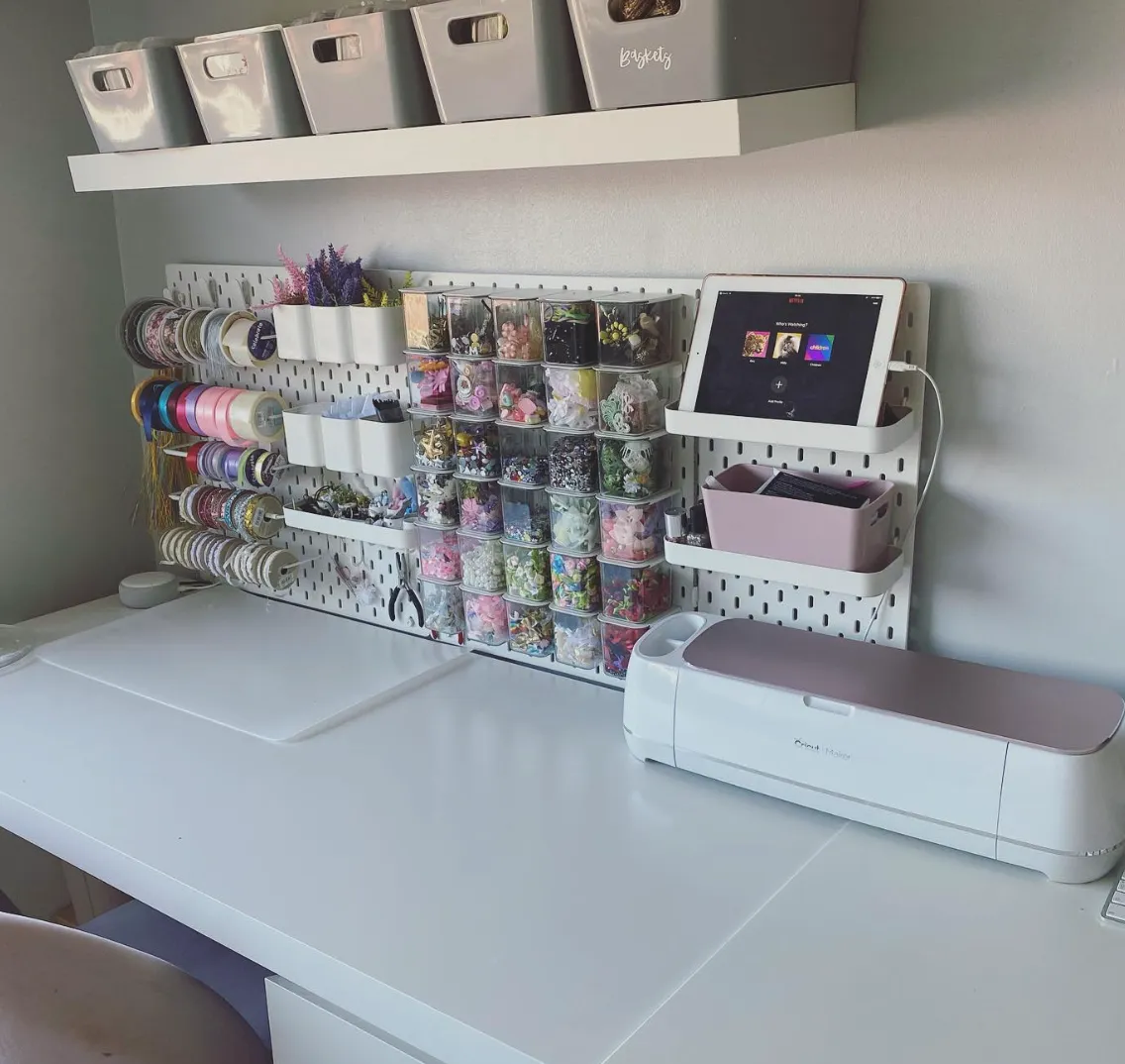 This setup makes use of every inch with a pegboard mounted above the desk for tools and embellishments, while the labeled bins on the shelf above add a chic, uniform look.