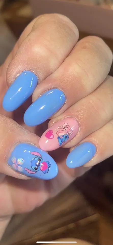 For a softer, more romantic take on Stitch, this pastel combo mixes baby blue and blush pink with delicate character decals. The glossy finish keeps it classy and wearable for any trip to Disney World.