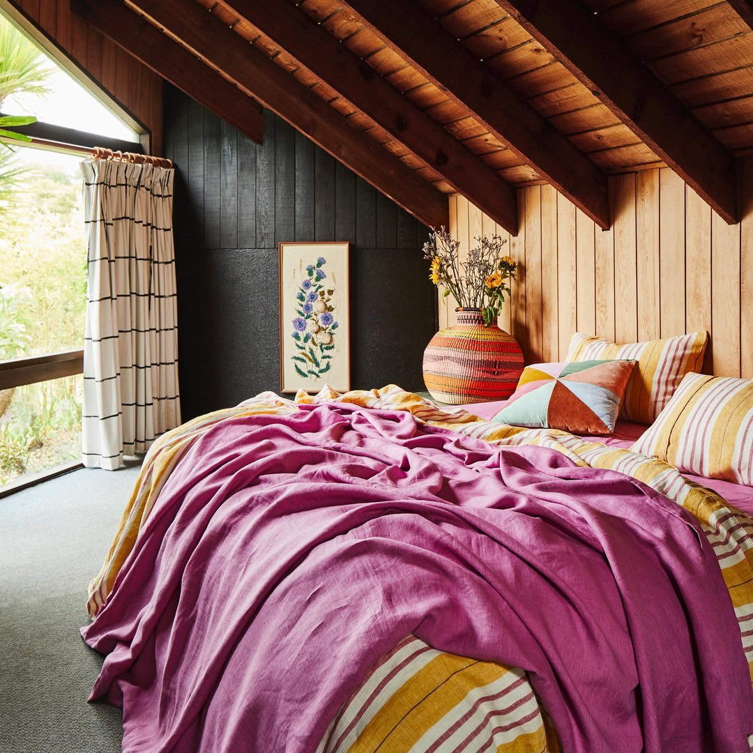 Instead of placing your throw at the foot of the bed, try tossing it over one side for a more laid-back, inviting feel.