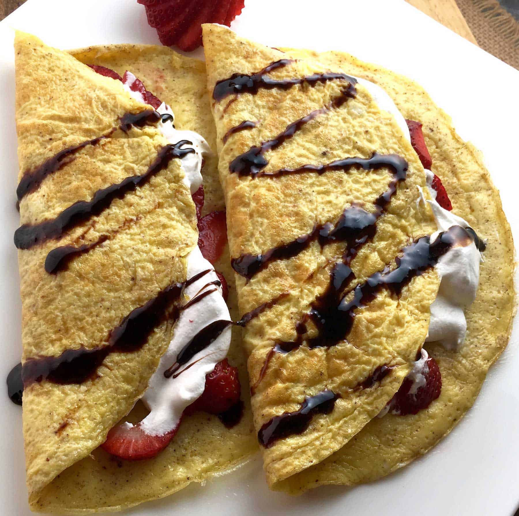 These gluten free flourless crepes are delicious wrapped around fresh strawberries and drizzled with a maple whipped cream!