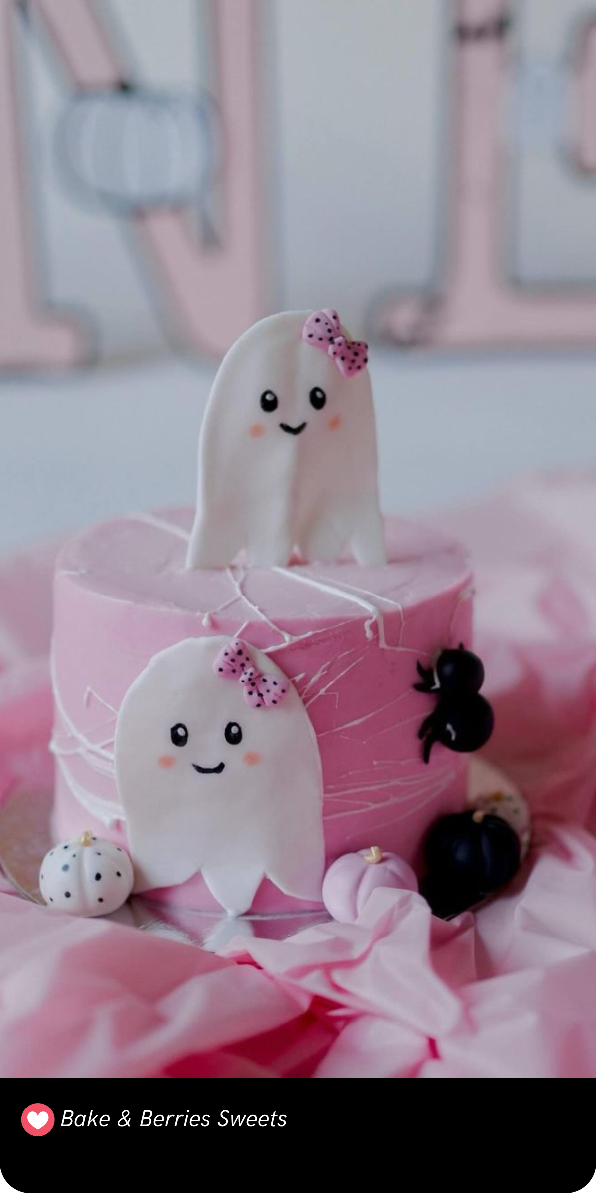 Wrapped in soft pink icing, this charming "Spooky One" cake features the cutest little ghosties with pink bows, perfect for a first birthday celebration with a touch of Halloween fun.