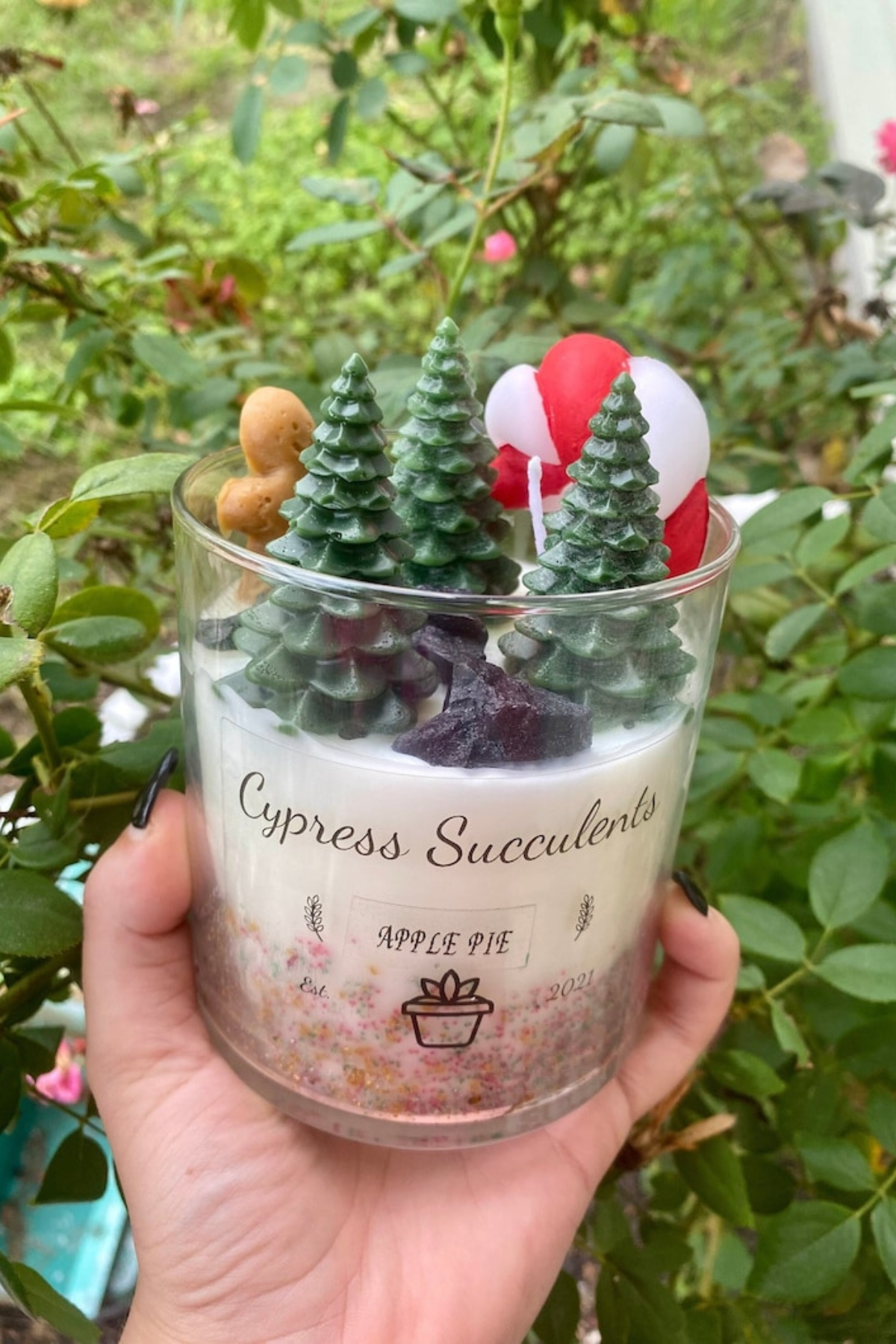 Filled with festive shapes like candy canes, gingerbread men and Christmas trees, this handmade soy candle brings the fresh scent of apple pie right into your home — a fun, festive addition to any space!