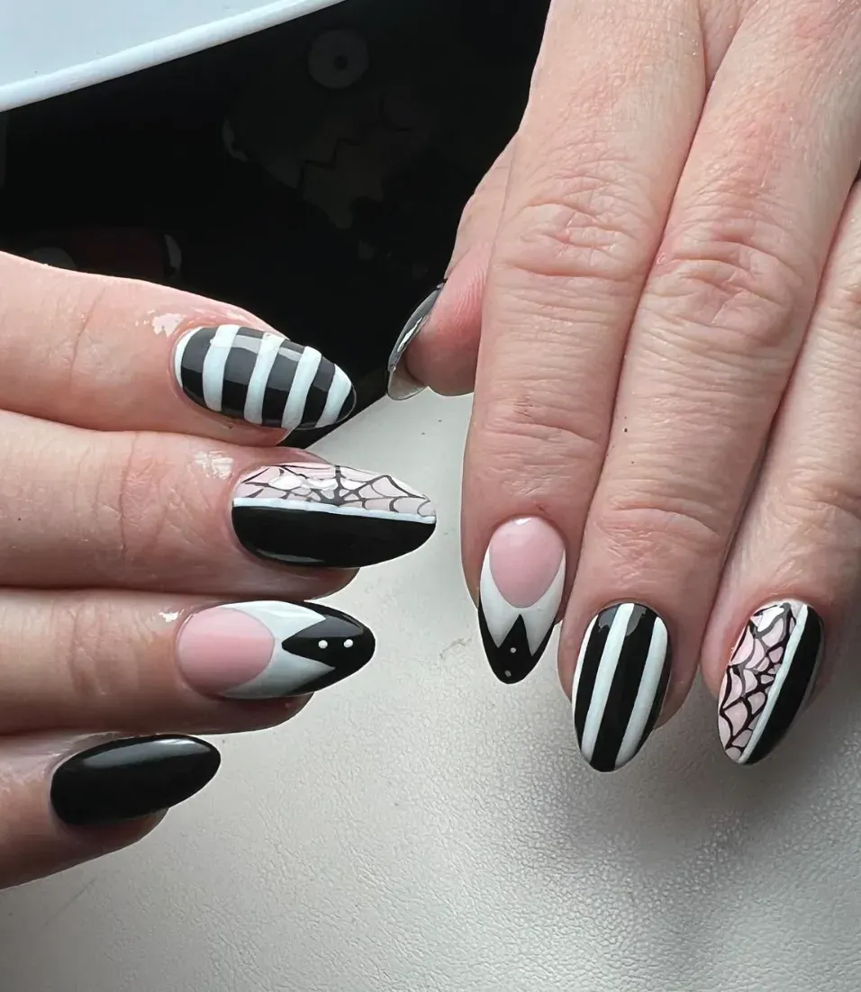This creative set takes inspiration from the stained glass and shadows of Nevermore Academy, complete with silhouettes and school crest details — total art on nails.