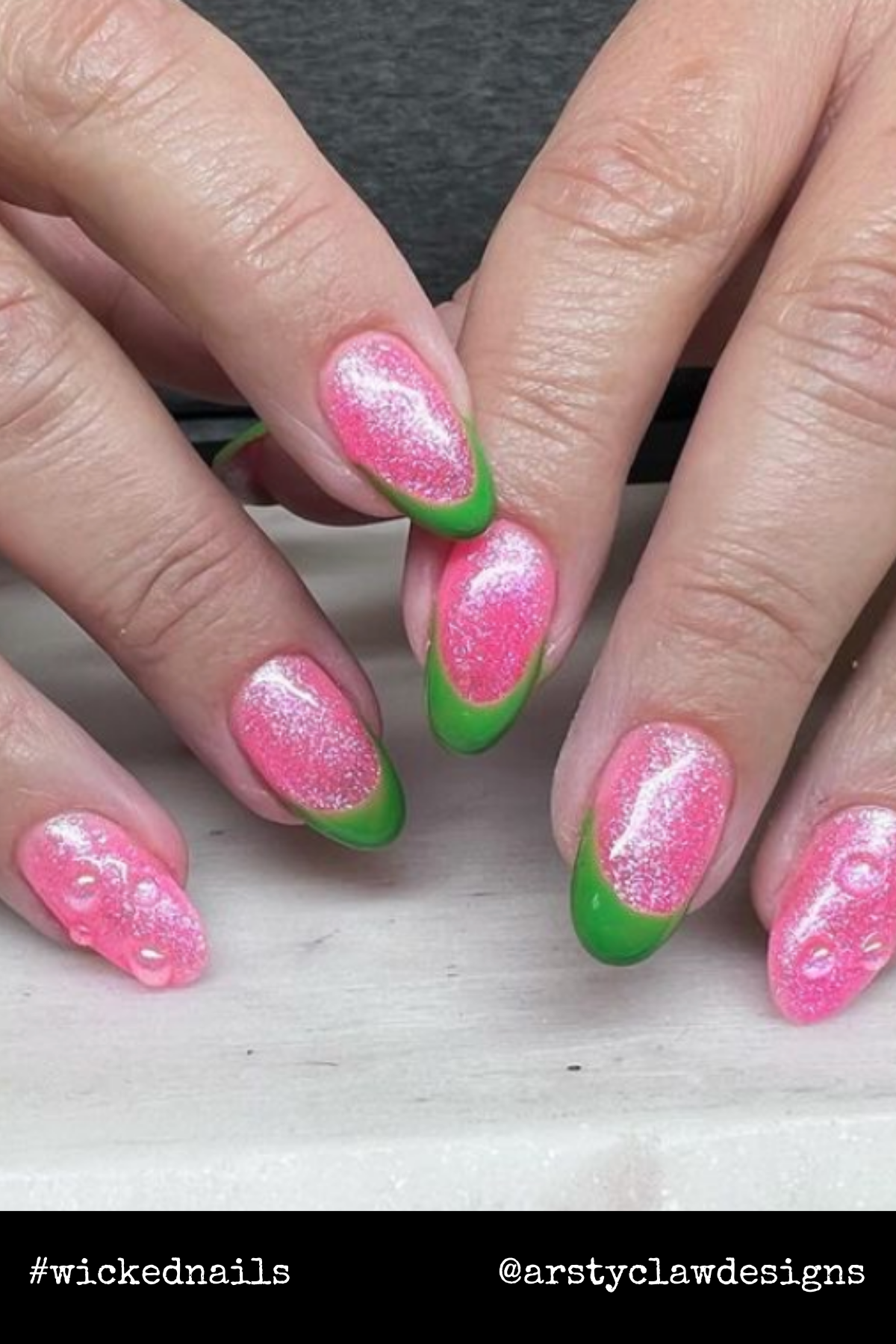 Glittery pink French tips with a wicked green edge bring a fresh and flirty take on the Glinda-meets-Elphaba aesthetic.