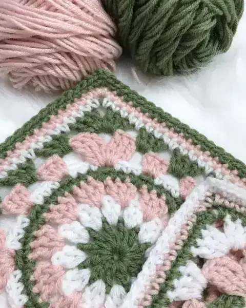Calling all Granny Square fans! Today we're sharing this dainty Wispy Willow crocheted square with a charming floral center that elegantly expands into a lovely square frame. You can use any number of colors from three to seven to create a unique granny square that you can then turn into a blanket or a pillow.