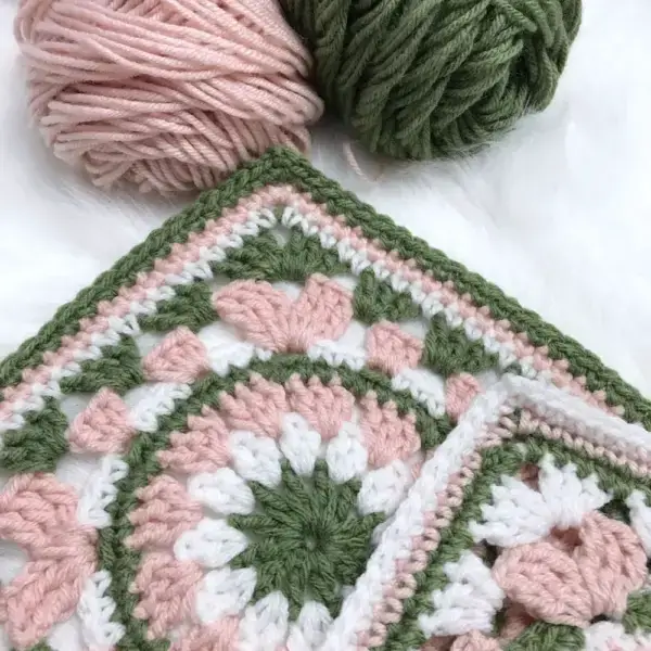 Calling all Granny Square fans! Today we're sharing this dainty Wispy Willow crocheted square with a charming floral center that elegantly expands into a lovely square frame. You can use any number of colors from three to seven to create a unique granny square that you can then turn into a blanket or a pillow.