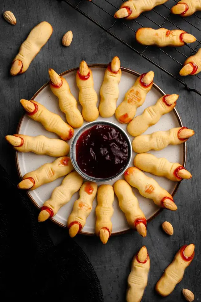 These creepy witch finger cookies are a Halloween classic! Shaped like gnarly fingers and finished with almond ânailsâ and a dab of red jam, theyâre scary good fun.