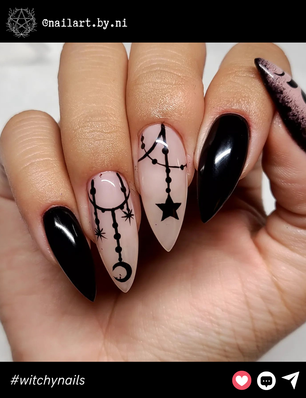 Long Black and Nude Celestial NailsLong stiletto nails with a nude base and black accents, featuring dangling moon and star designs. These are for anyone who loves celestial elements in a sleek, modern package. The length adds the right amount of drama!