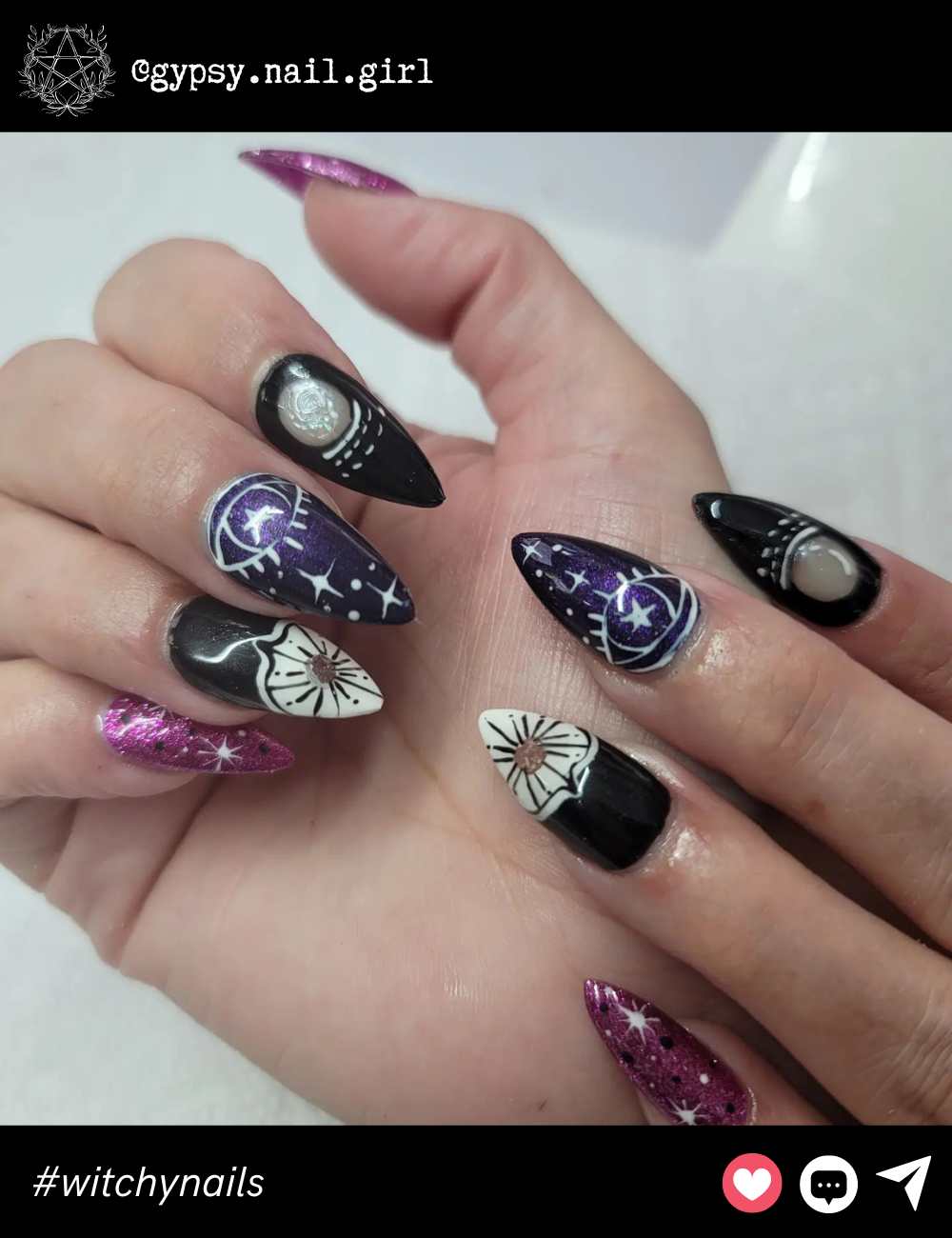 Starry Purple and Black Celestial NailsThese long stiletto nails feature a stunning combination of dark purple and black with intricate white celestial designs. The glowing moons and stars are perfect for anyone looking to make their witchy side shine, while the glitzy pink accent nail adds an extra sprinkle of magic.