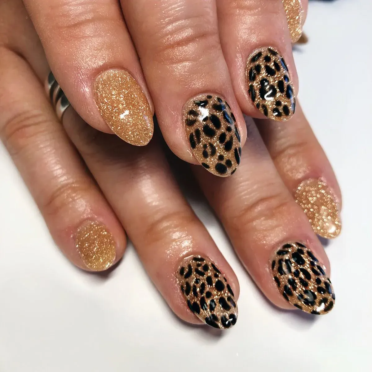 Short nails can still make a statement! These simple cheetah nails combine gold glitter and glossy black spots for a fierce, easy-to-maintain mani that feels effortlessly stylish.