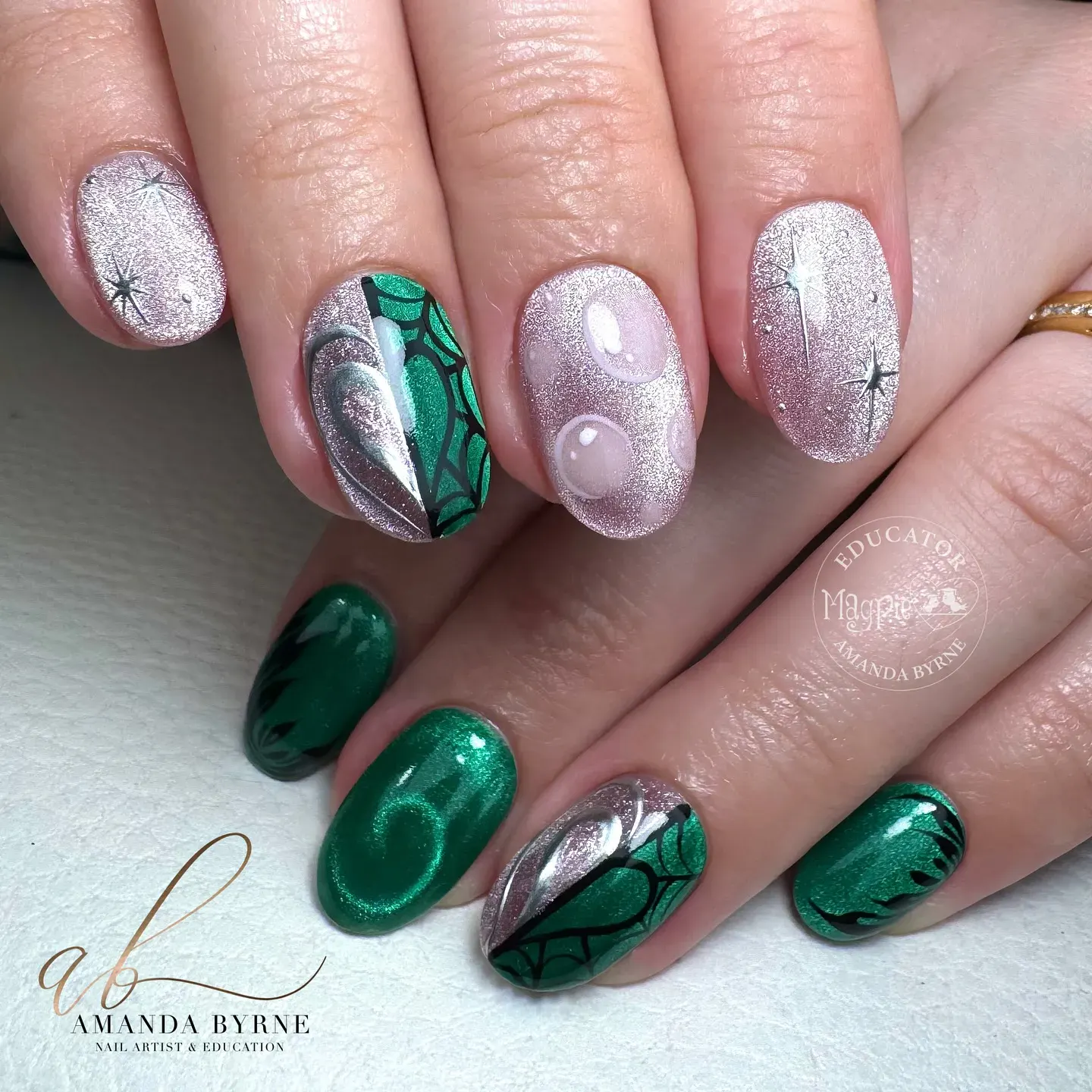 Deep metallic green meets fairy-dust pink with swirling shimmer and bubble details — just the right mix of good and wicked.