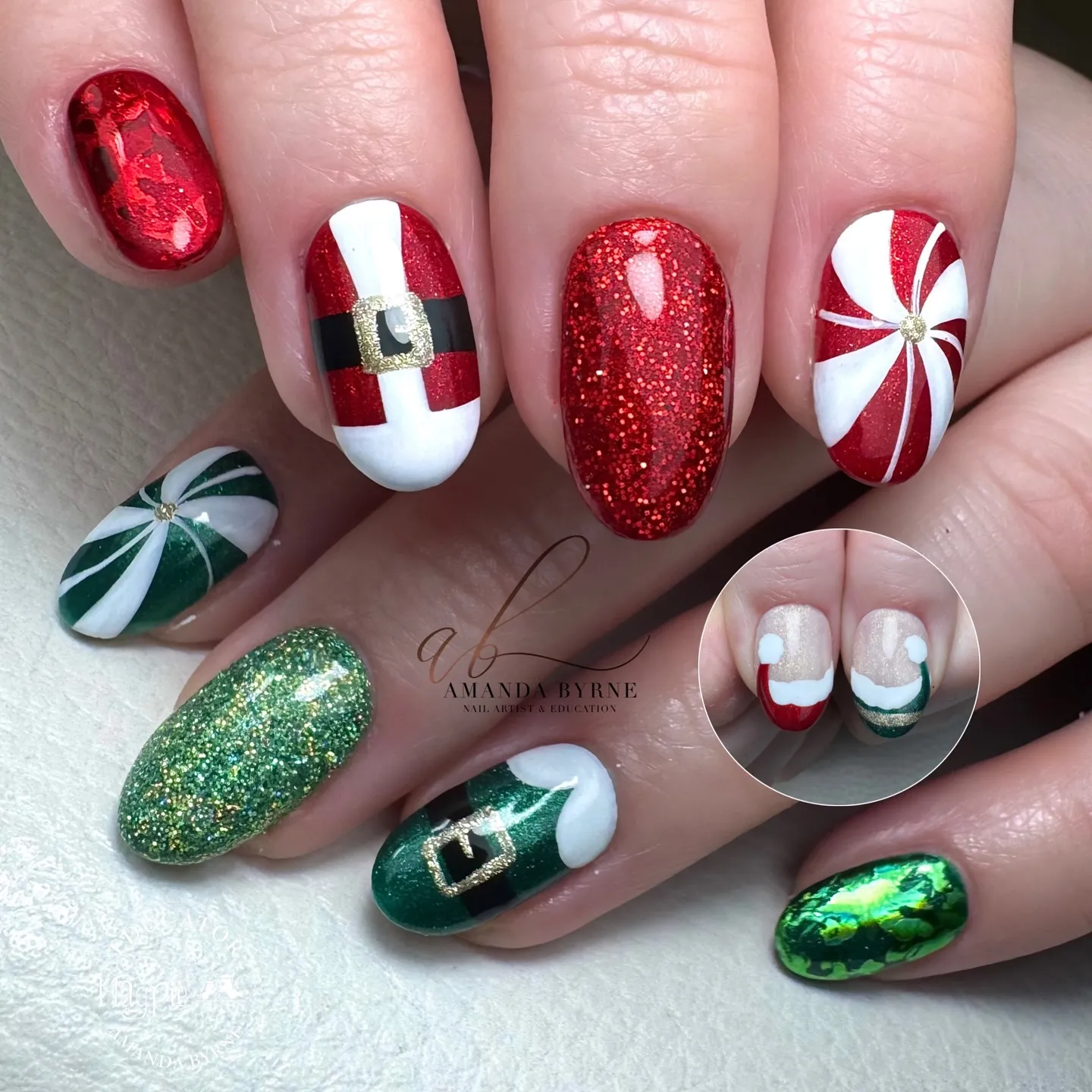 And finally, @amanda_byrne_nailartist went all out with a playful mix of Santa suits, elf belts, and peppermint swirls. Every nail tells its own story, making this the ultimate Red Christmas Nails look for anyone who loves a bold, merry mani.