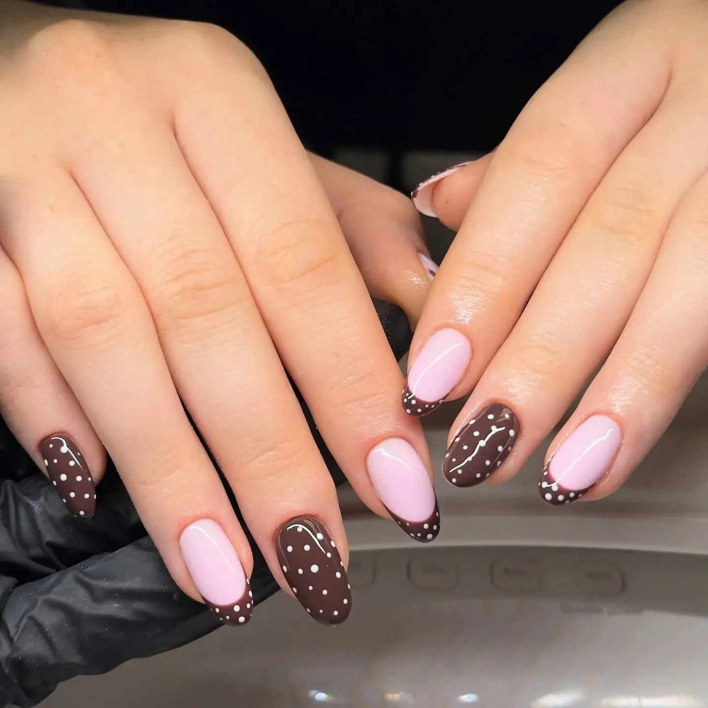 Soft pink nails get a cozy fall twist with glossy chocolate tips and tiny white dots — it’s giving hot cocoa and sweater weather!